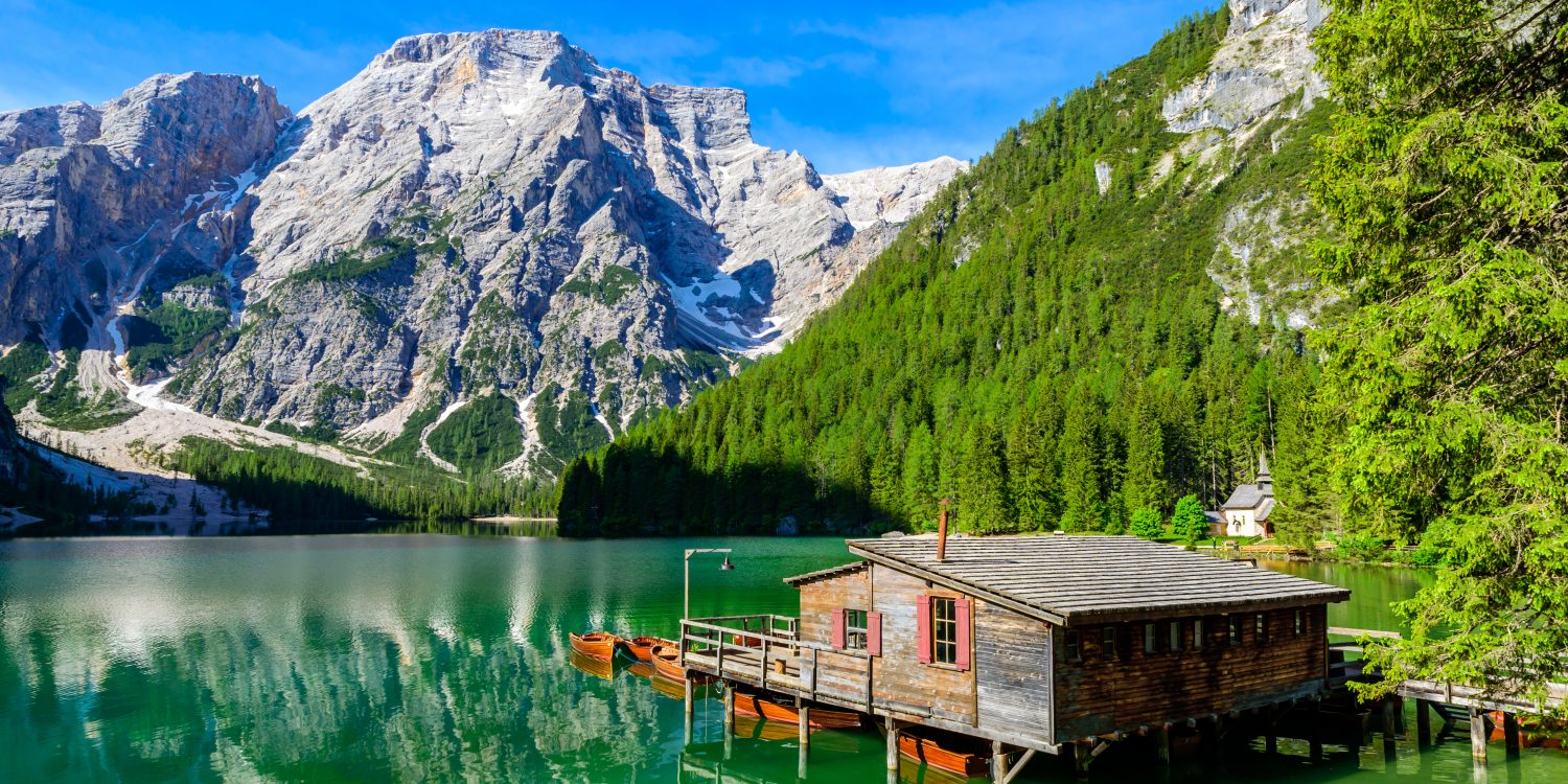 Lake Braies (also known as Pragser Wildsee or Lago di Braies) in Dolomites Mountains, Sudtirol, Italy. Romantic place with typical wooden boats on the alpine lake. Hiking travel and adventure. Pragsee